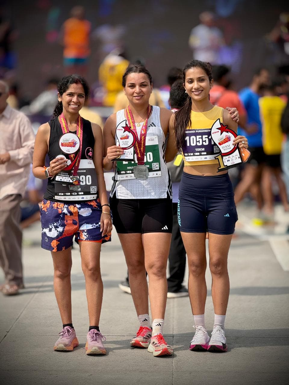 Mamta Yadav and Devangi Purkayastha on the Freedom Bengaluru Half Marathon 2026 podium